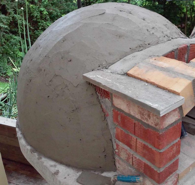 first coat of render on wood fired pizza oven dome