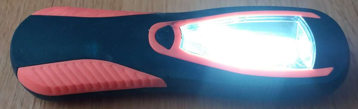 Battery operated LED work lamp with a magnet on the back